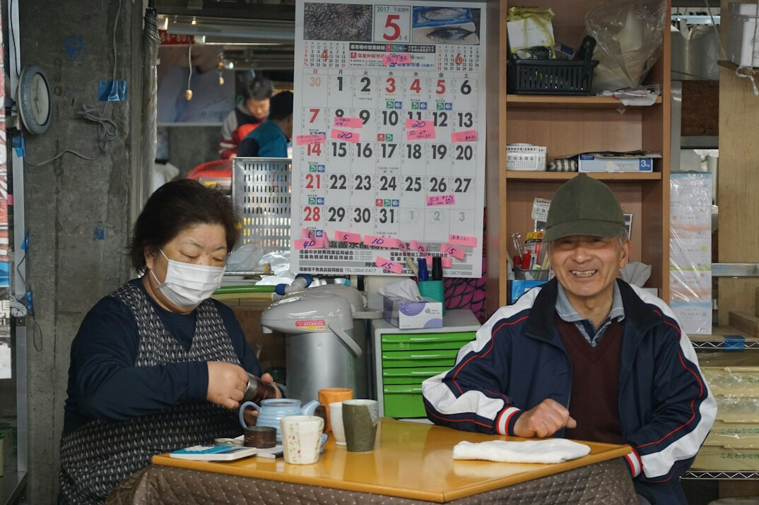 Elderly Japanese people enjoying a craft workshop together at a table