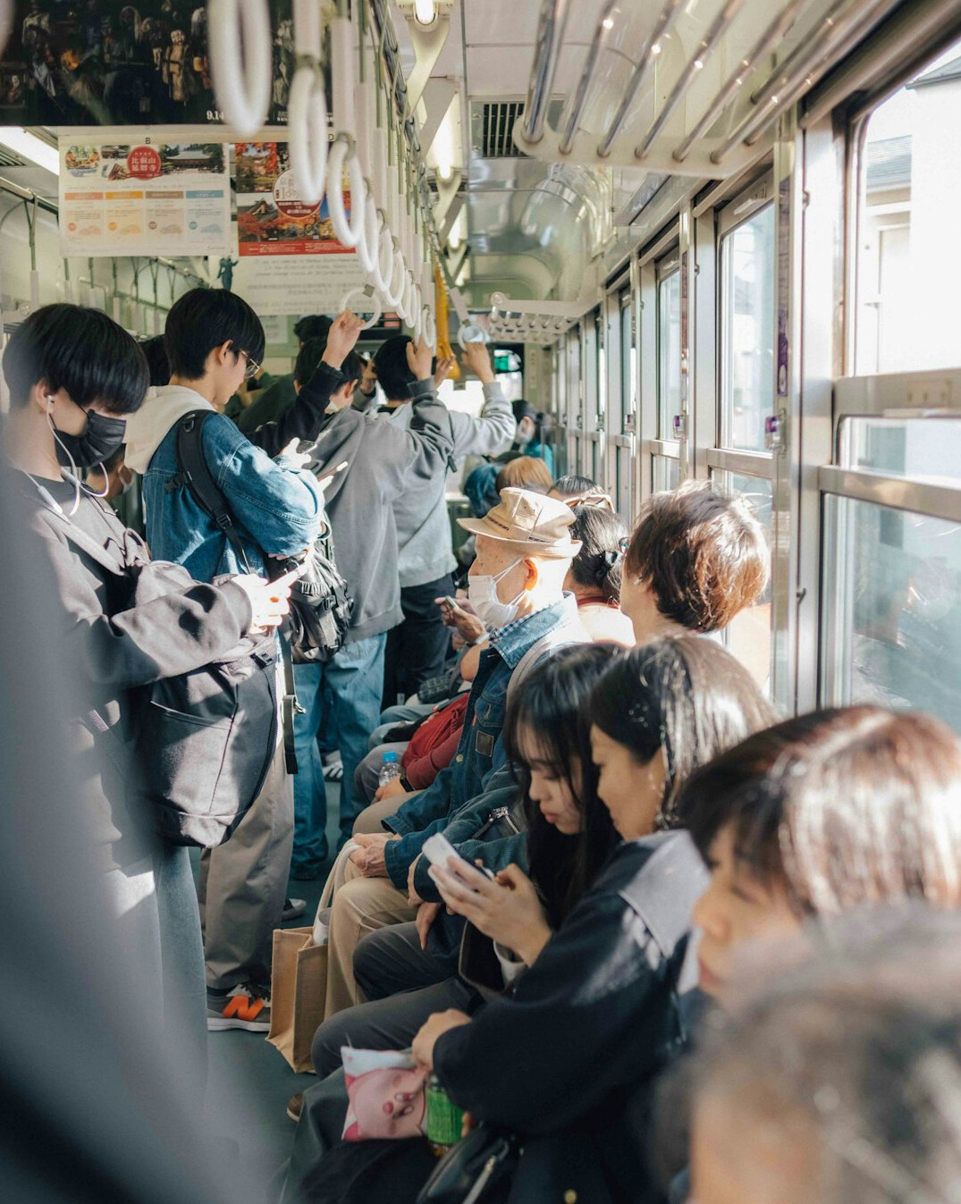 Group of Japanese seniors on a sightseeing bus trip smiling