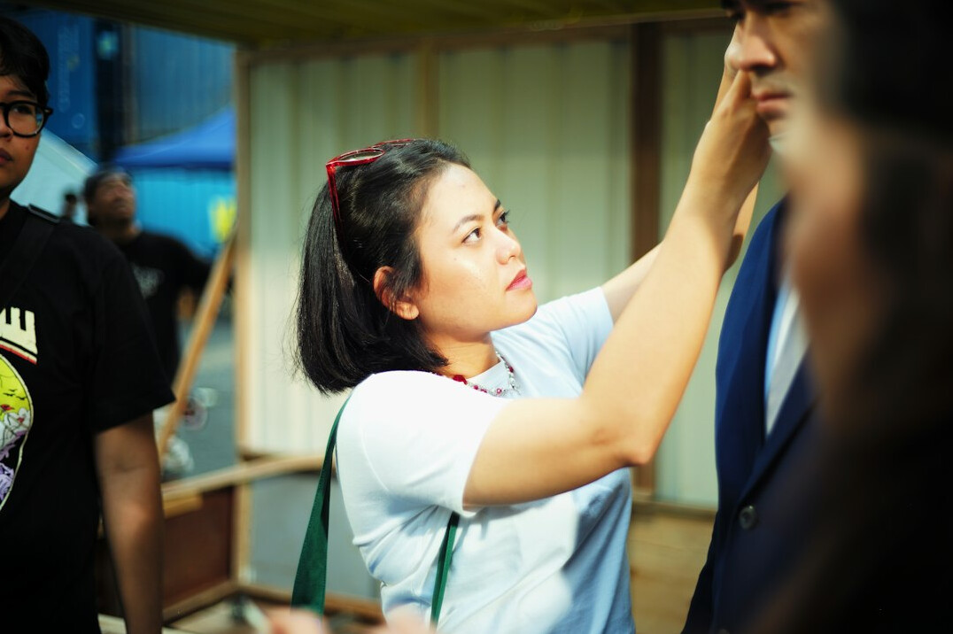 Friendly Japanese woman staff member ready to help with headset