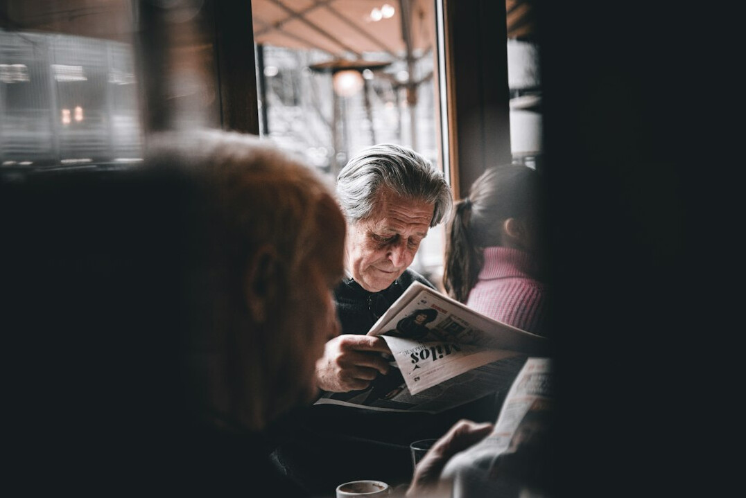 senior reading newspaper
