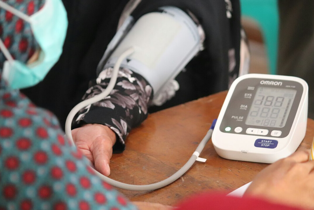 Japanese nurse checking blood pressure of an elderly patient